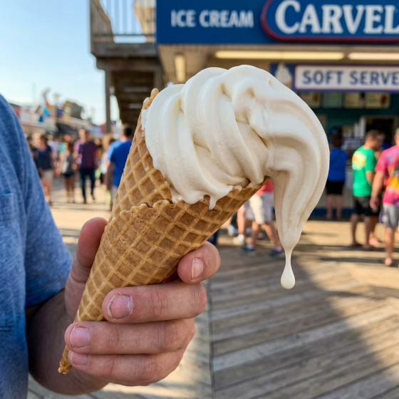Slanted melting ice cream cone with one drip
